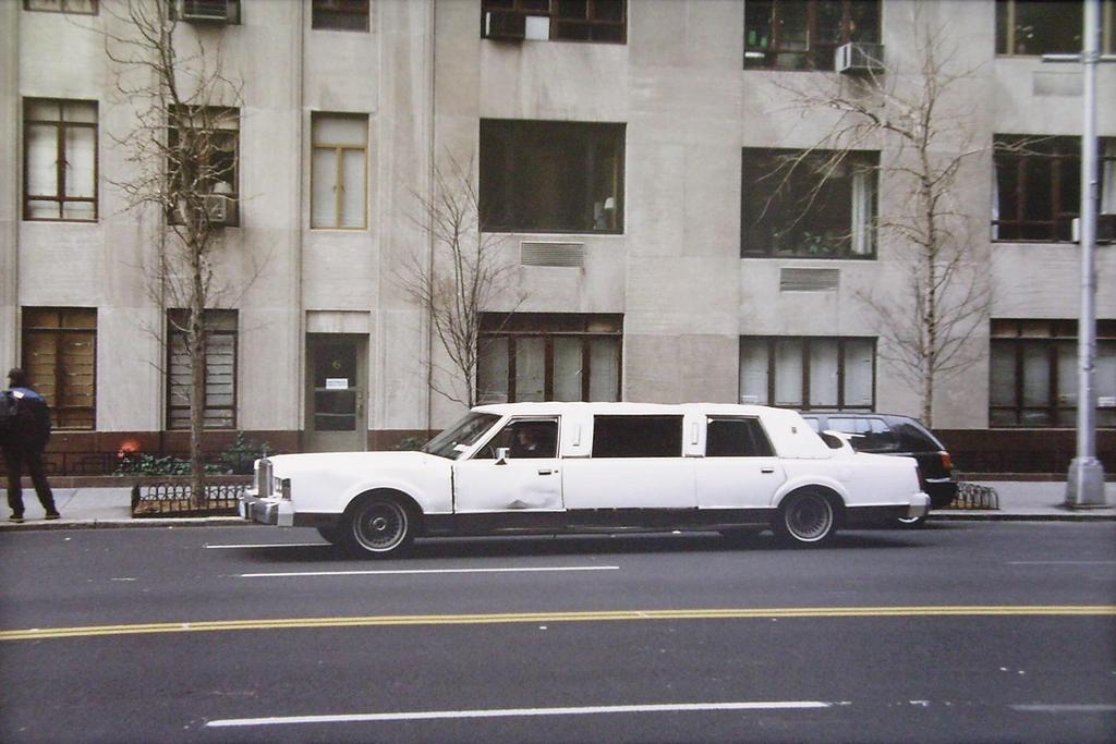 A white limousine that has seen better days.