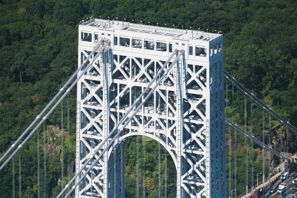 A close up of the George Washington bridge, over the Hudson, from a side angle.