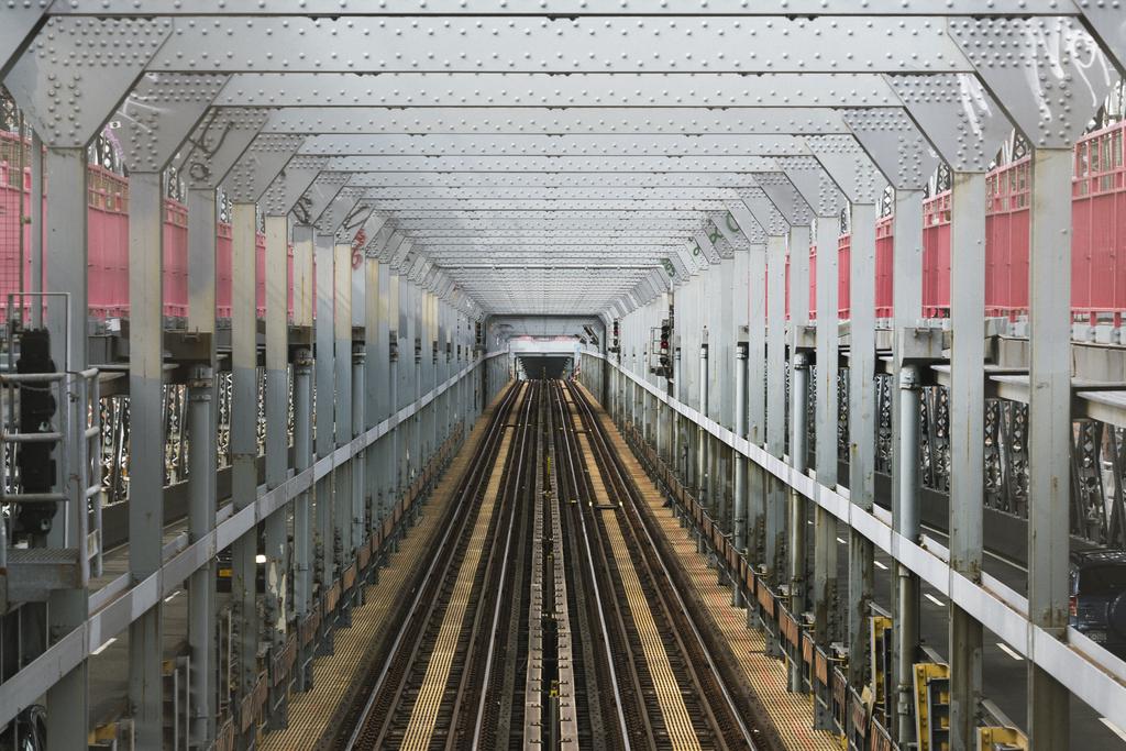 A symmetrical view of overland subway tracks on the Williamsburg bridge.